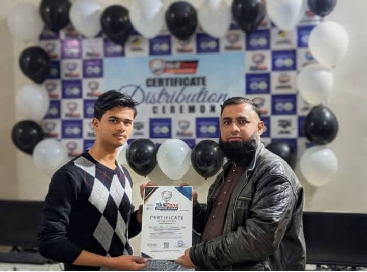 A student receives his certificate at the certificate distribution ceremony