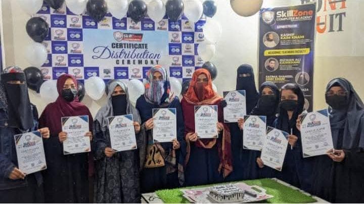 Students holding their certificates at the ceremony
